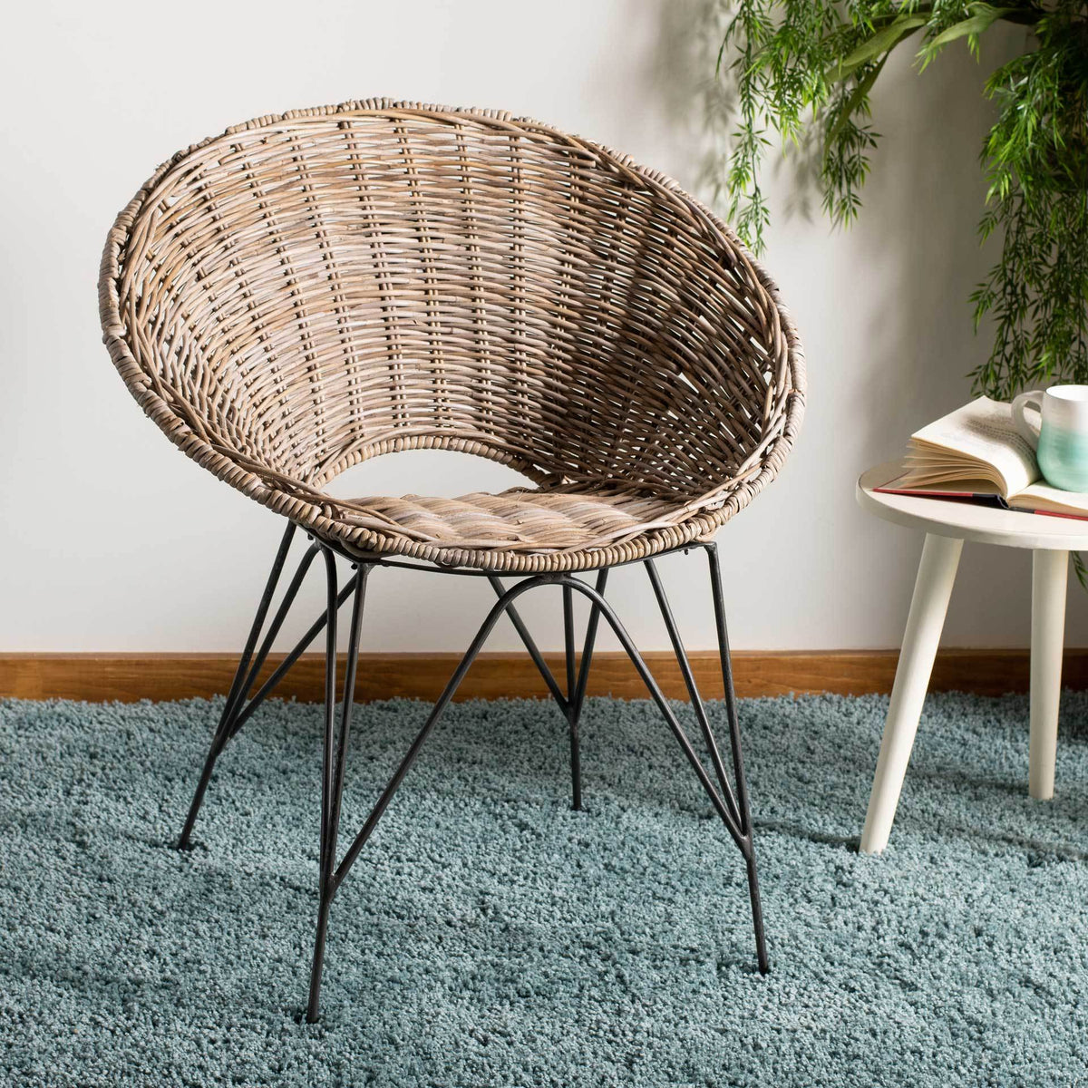 Pale woven rattan and dark steel legs bring relaxed texture to a living space