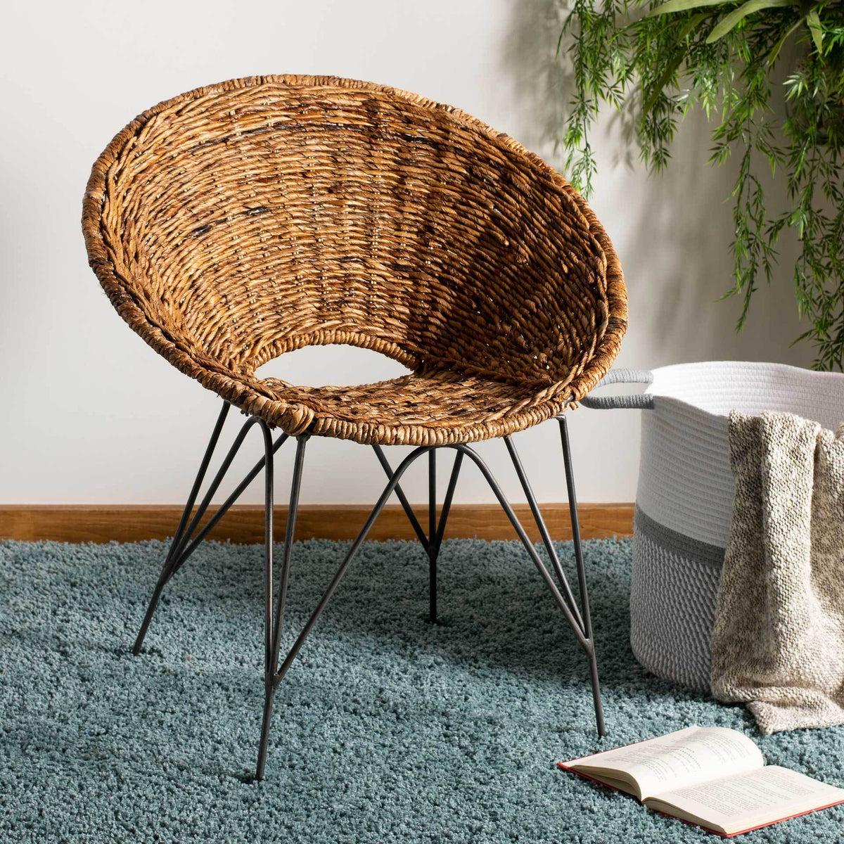 Rich woven rattan and slender dark legs add natural warmth to a living space