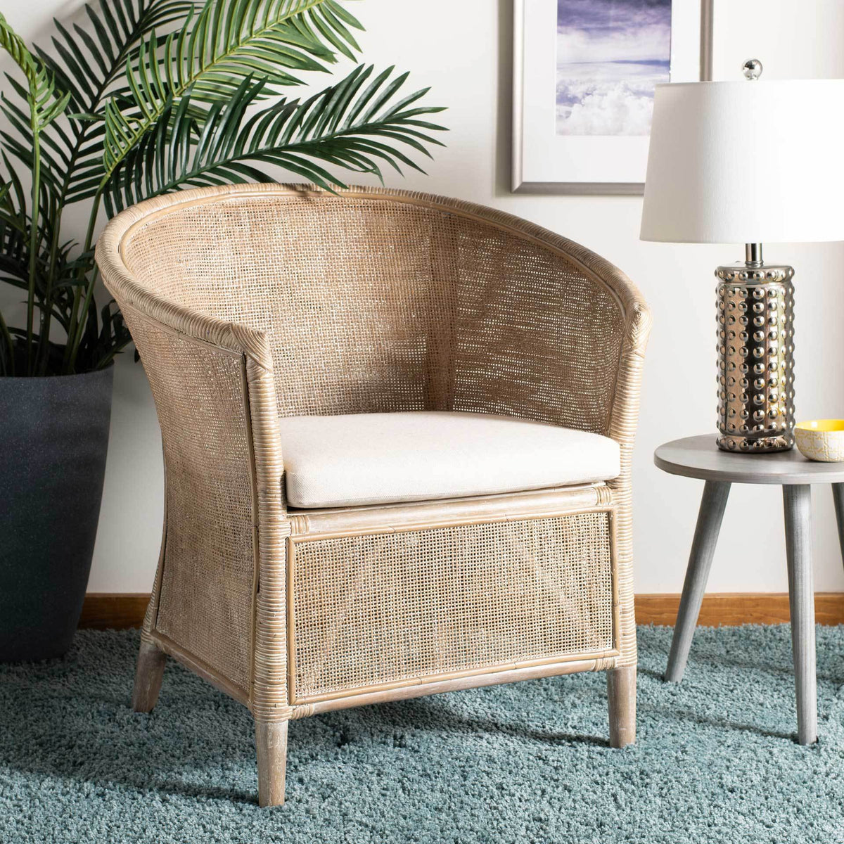 An airy rattan weave and cushioned seat bring breezy comfort to a relaxed living space.