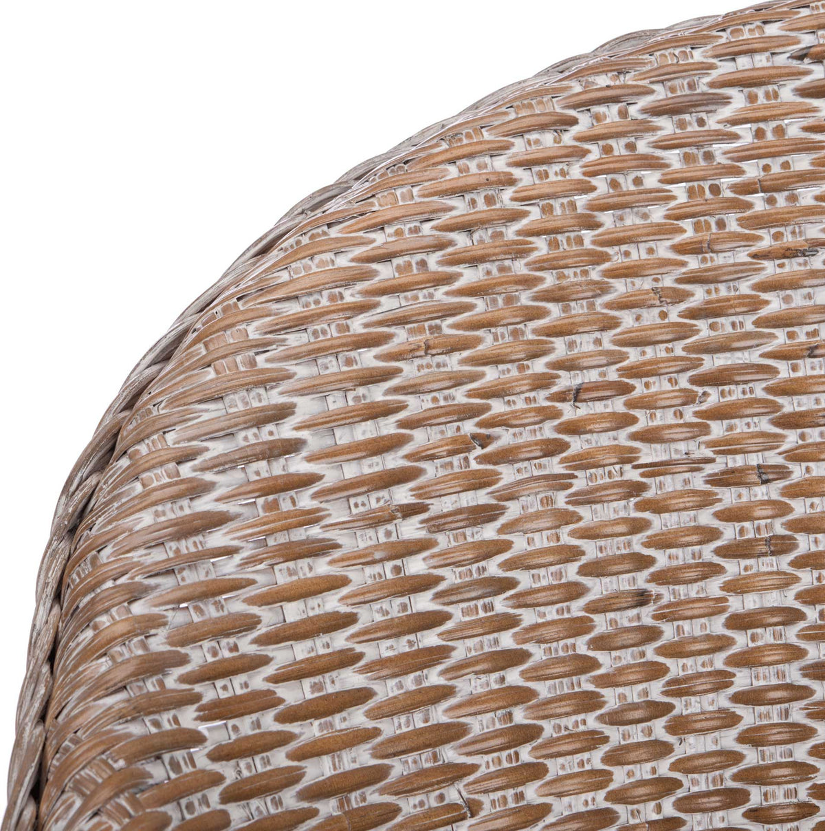 Whitewashed accents highlight the tightly woven rattan and braided edge of the curved chair back.