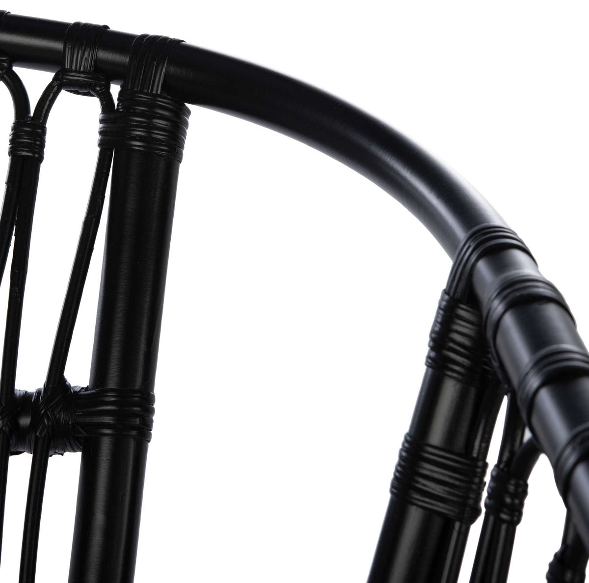 Smooth black rattan sweeps around the backrest with neatly wrapped joints