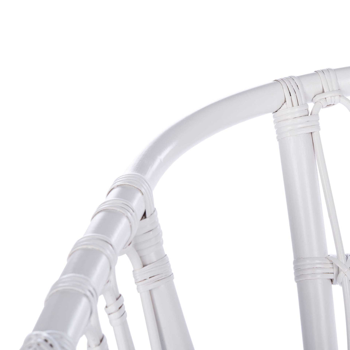 Rounded white rattan rail and wrapped connections define the chair's gently curved back