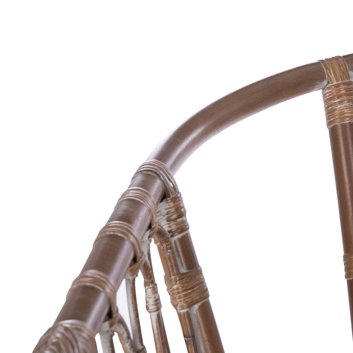 Subtle whitewashed accents follow the curved rattan rail and its tightly bound joints