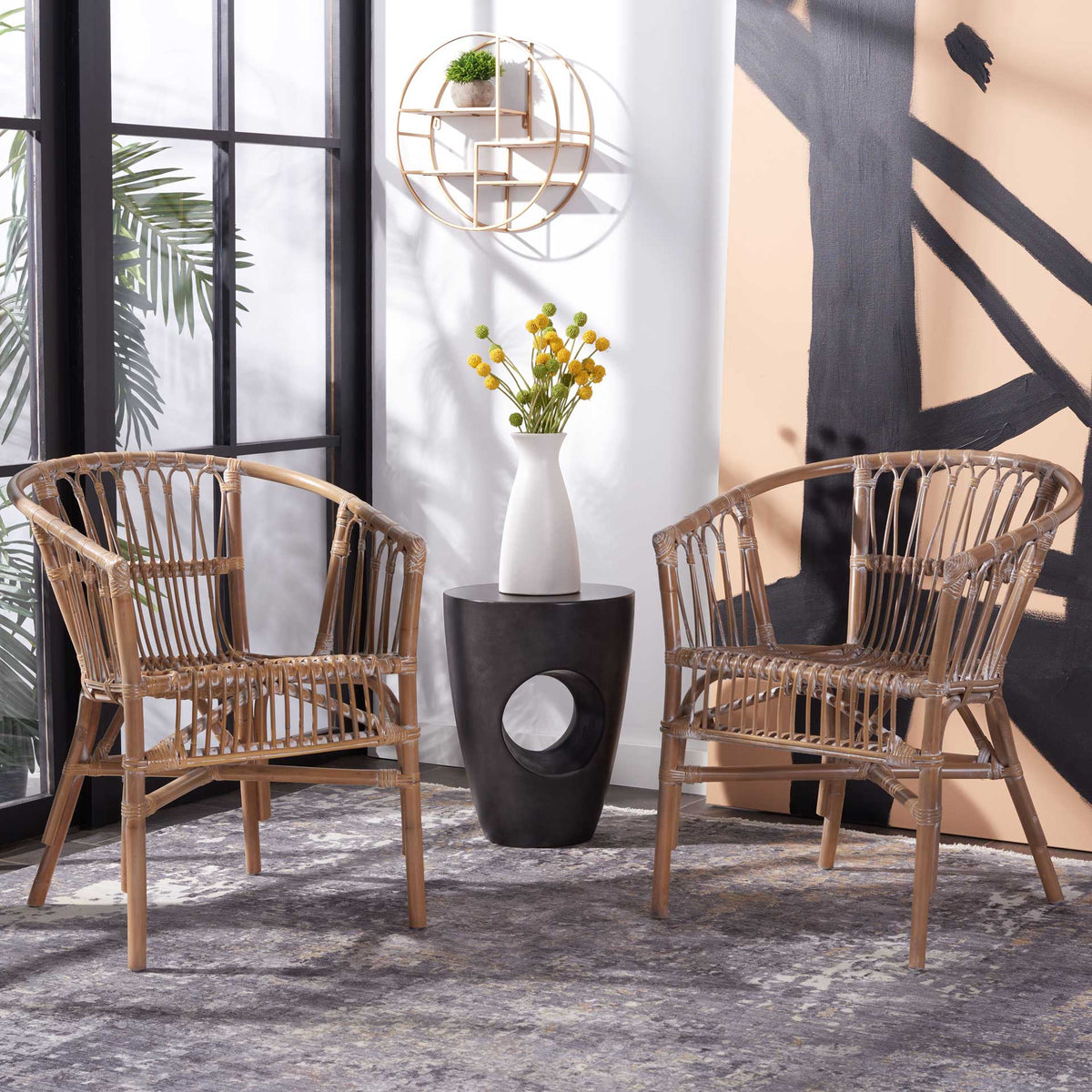 A pair of gray-whitewashed rattan chairs adds softly curved backs and woven texture to the space