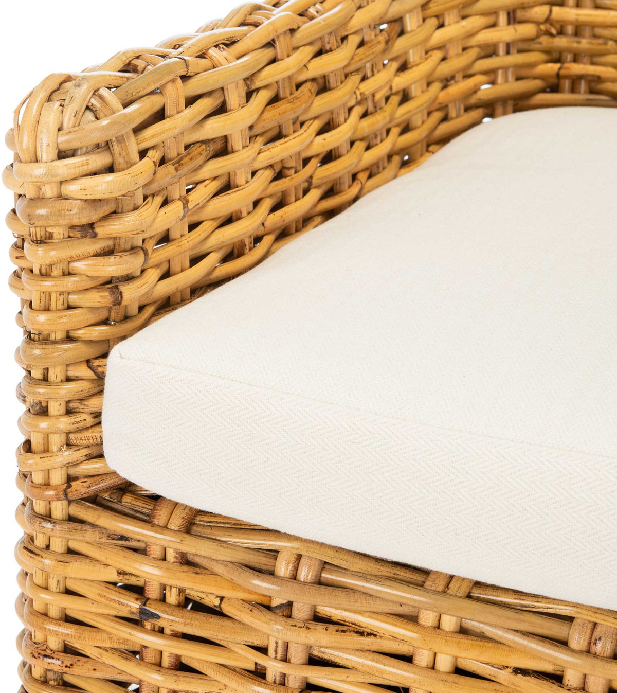 A plush white cushion rests within a natural woven rattan frame with rounded, layered arms