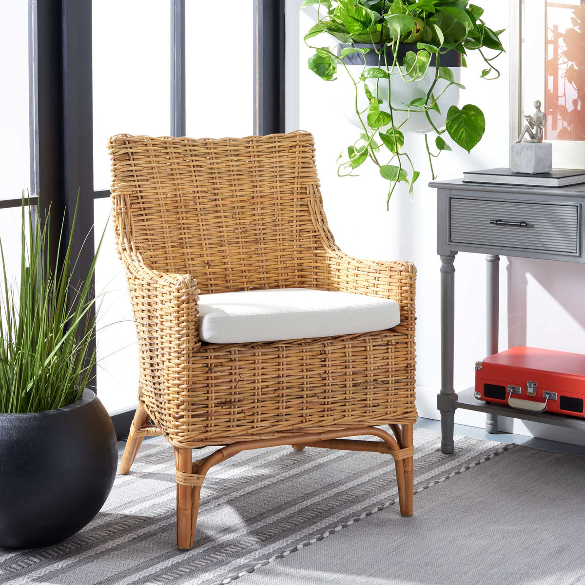 Natural rattan weave and a white seat cushion lend inviting warmth to a bright living space