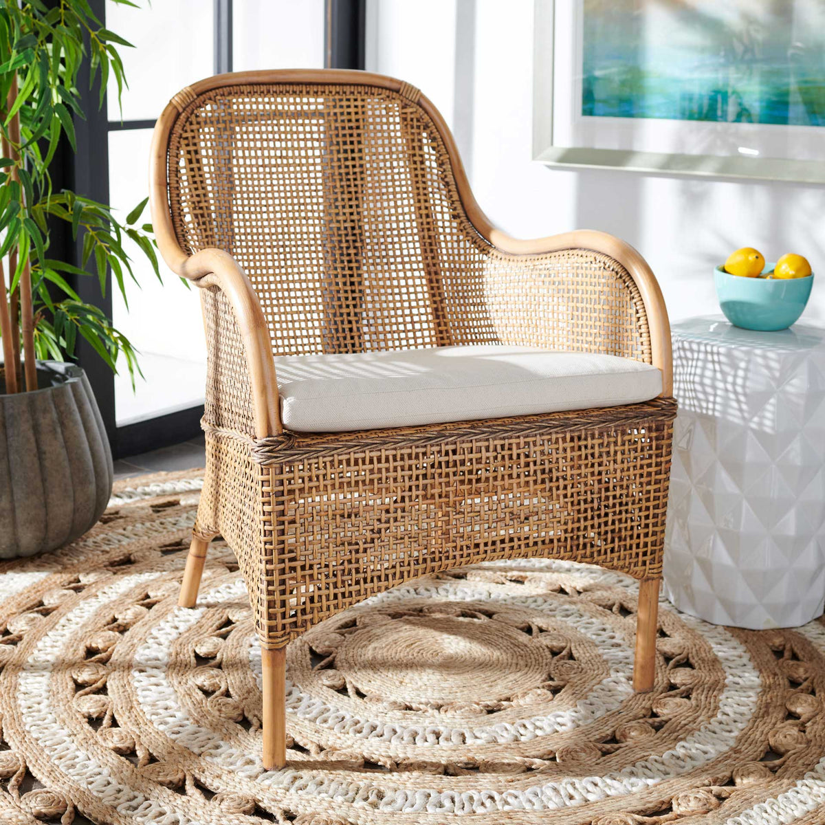 Curved honey-brown rattan and a white cushion lend warm, natural texture to a cozy seating area.