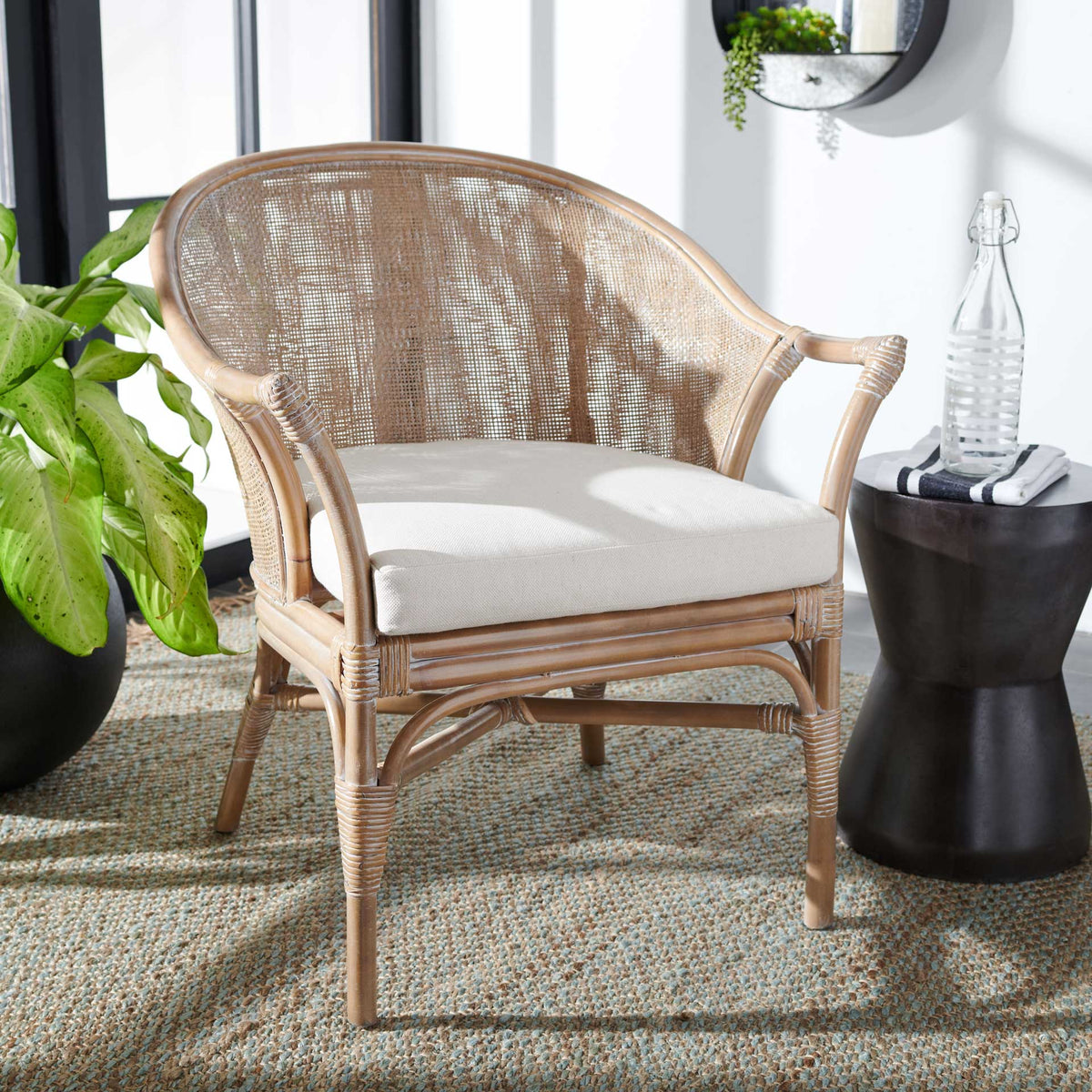 Pale washed rattan and a white cushion bring breezy comfort to a bright living space