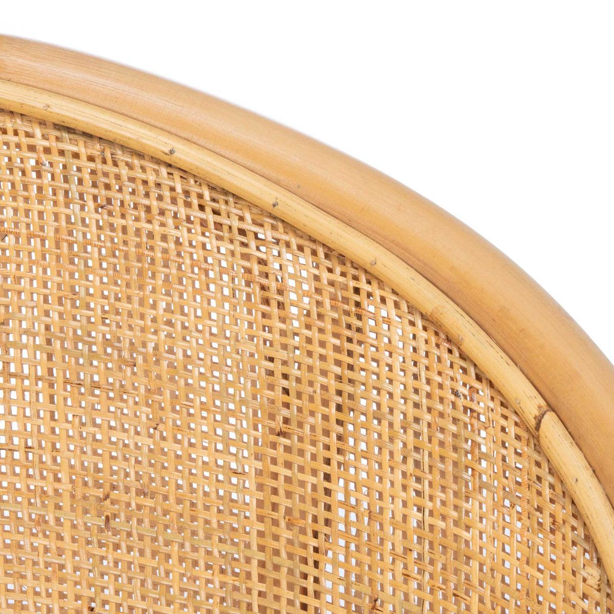 Warm natural rattan edging outlines the intricate open weave of the curved back