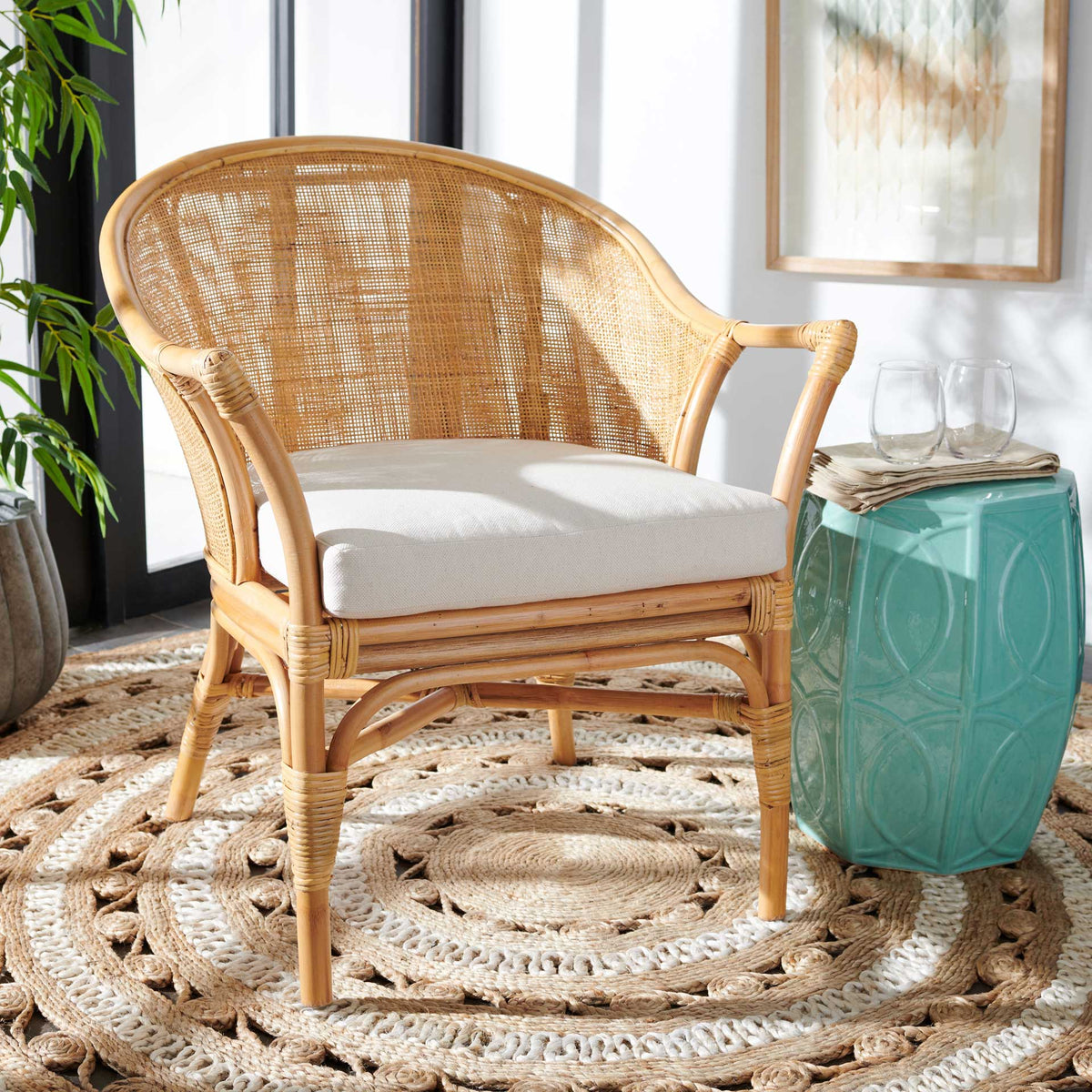 Warm woven rattan and a white cushion add an inviting coastal touch to a bright living room