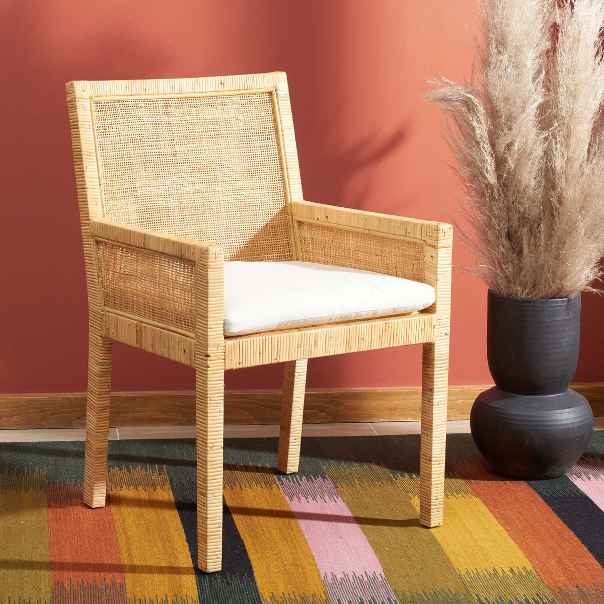 A white cushion contrasts with warm woven cane for a relaxed coastal look.