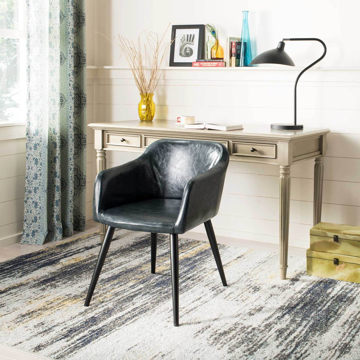 A dark gray faux leather seat pairs a sculpted, wraparound back with slim black legs.