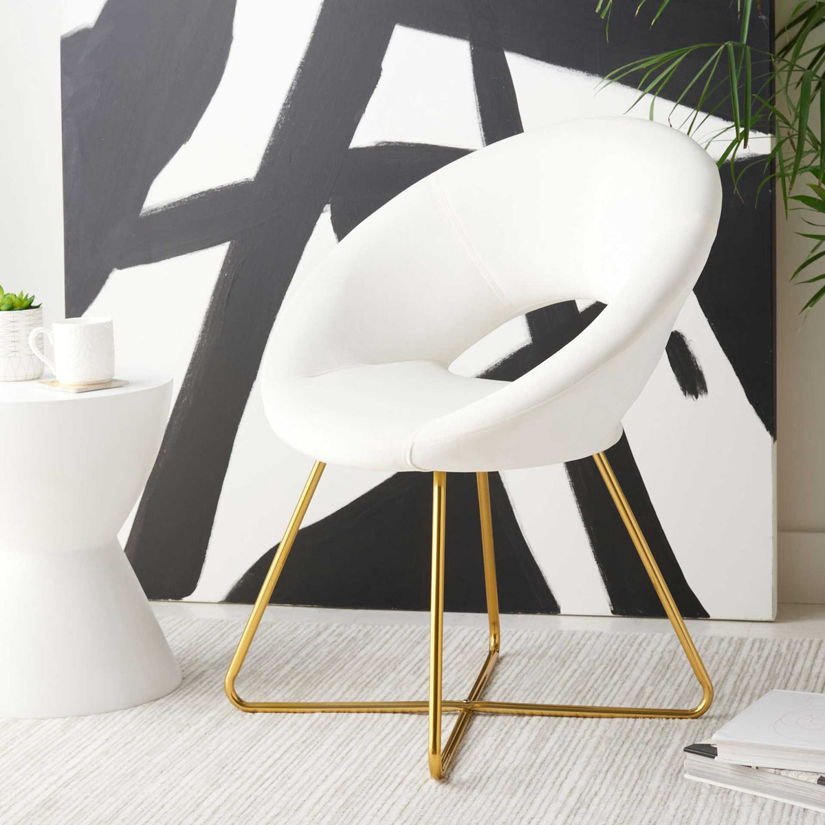 Ivory velvet accent chair pairs a sculptural seat with slim gold metal legs