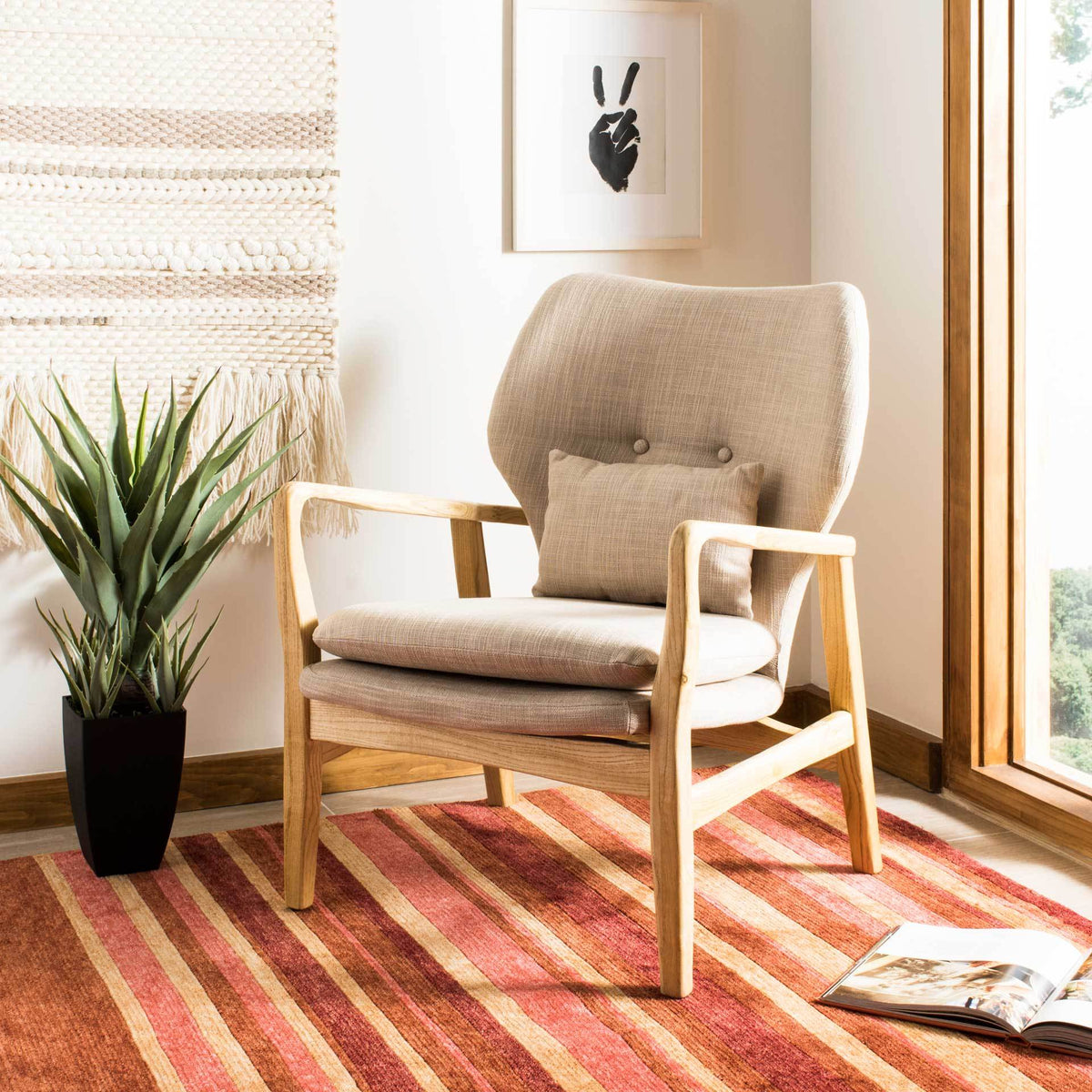 Soft beige cushioning and a curved natural wood frame bring inviting mid-century comfort to a living space