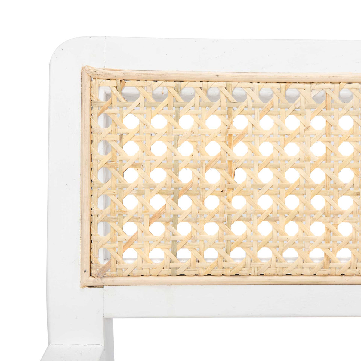Open cane lattice lends delicate texture to the chair's smooth white backrest frame.