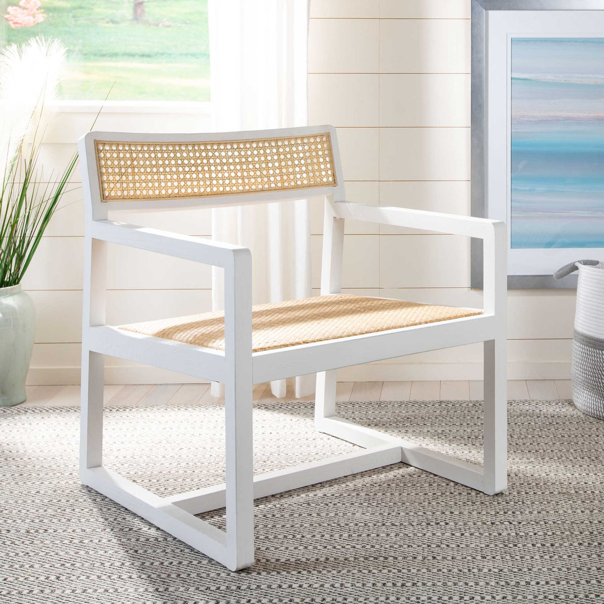 White wood and honey-toned cane give this open-frame chair an airy, coastal look.
