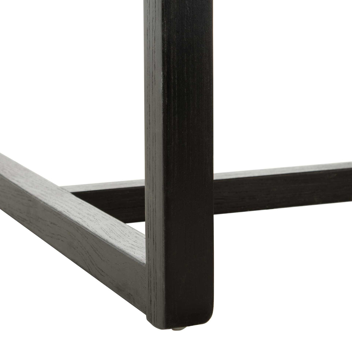 A black wood leg joins low horizontal rails to form an open, geometric chair base.