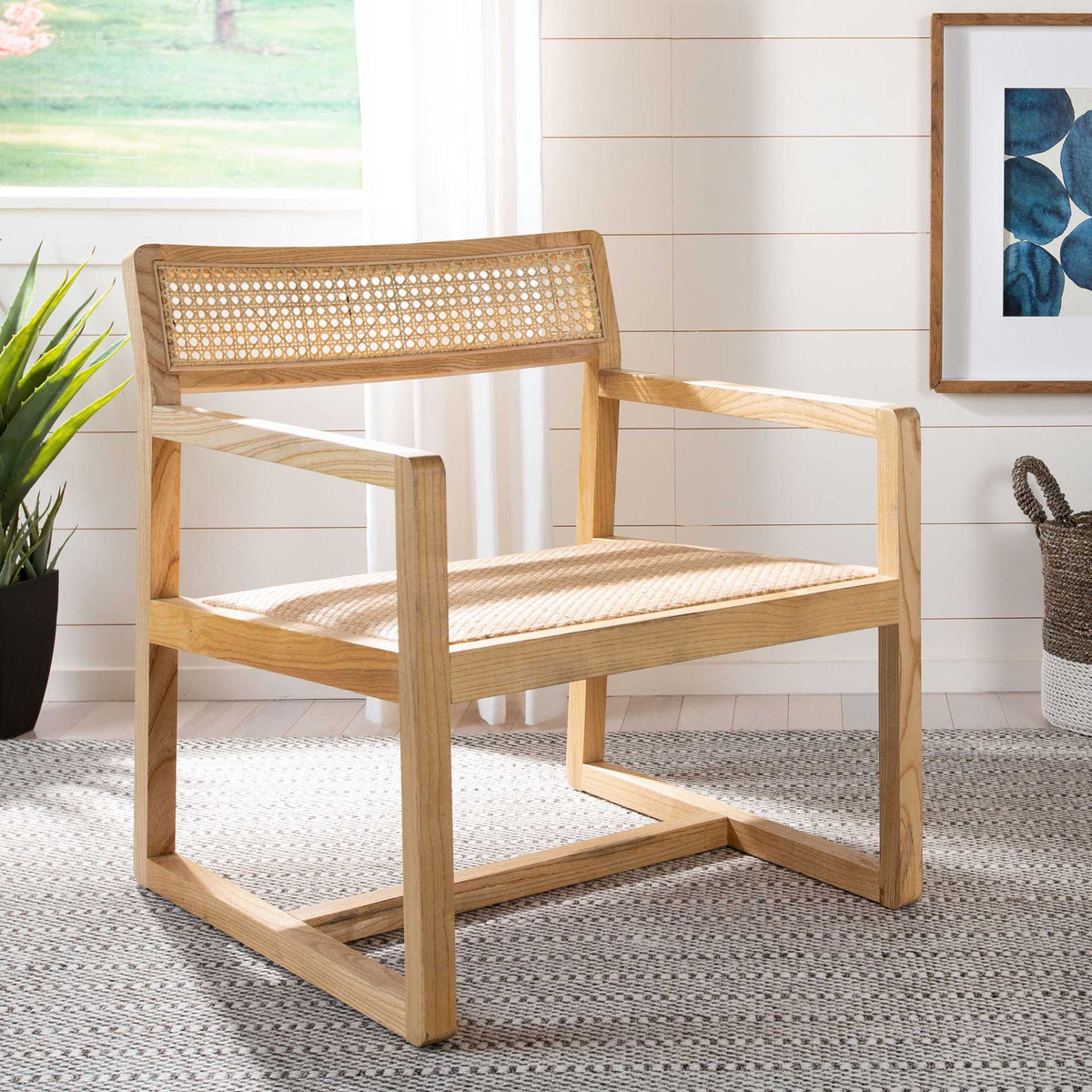Warm wood grain and woven cane give the open-frame chair a relaxed, coastal feel.