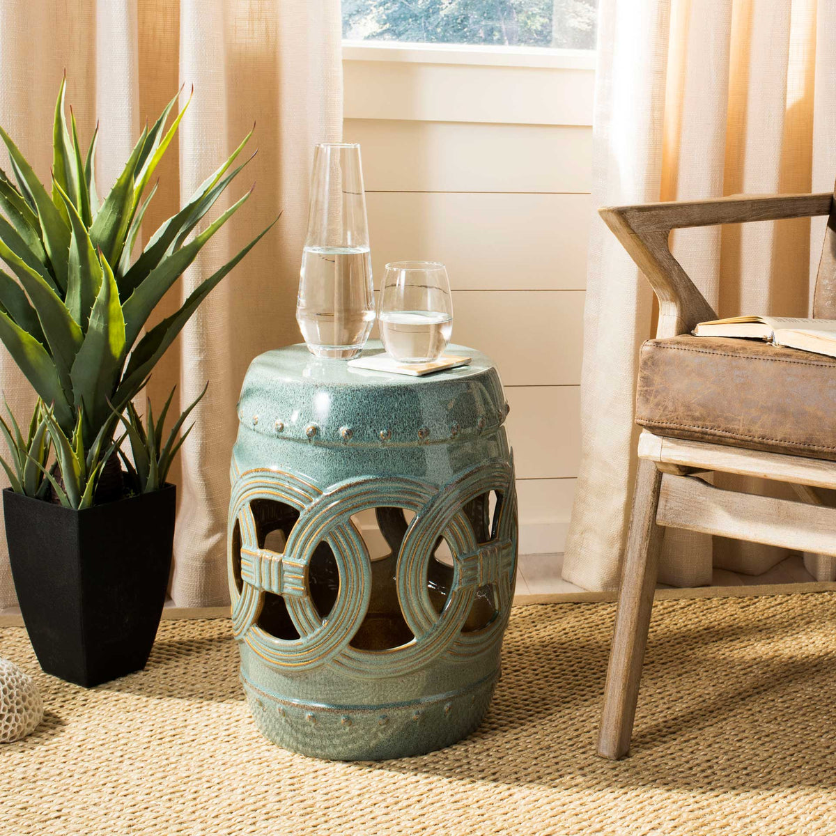 Open coinwork and a flat top make this blue ceramic stool a striking side table