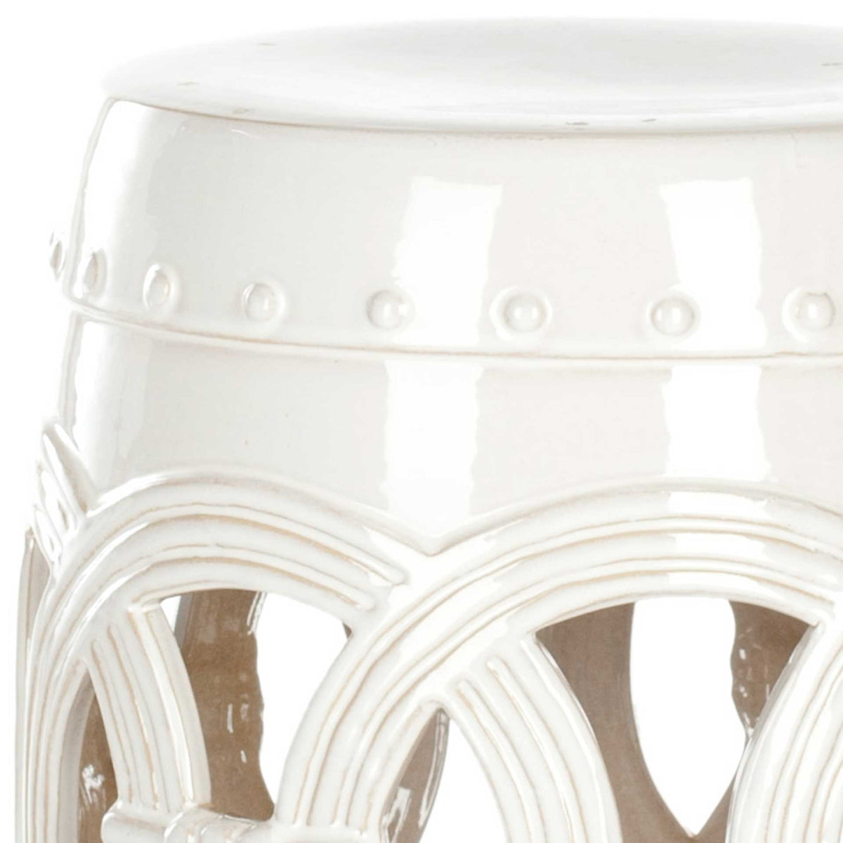 Glossy white ceramic reveals raised dot trim and layered coinwork detailing