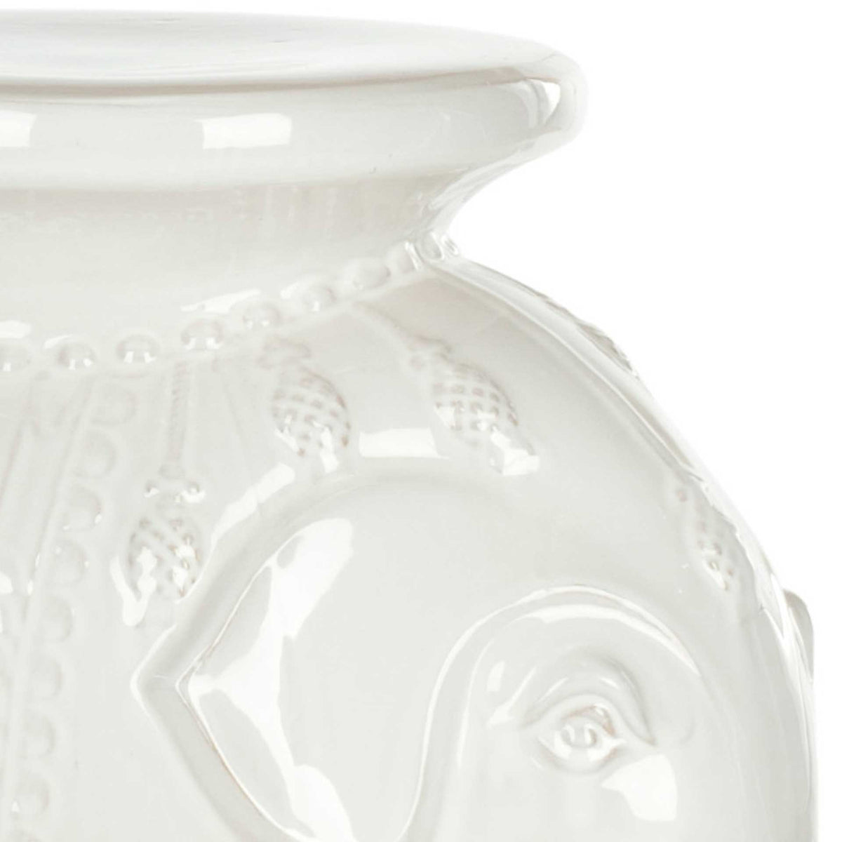 Glossy white glaze defines the elephant's sculpted ear, raised trim, and smooth top.
