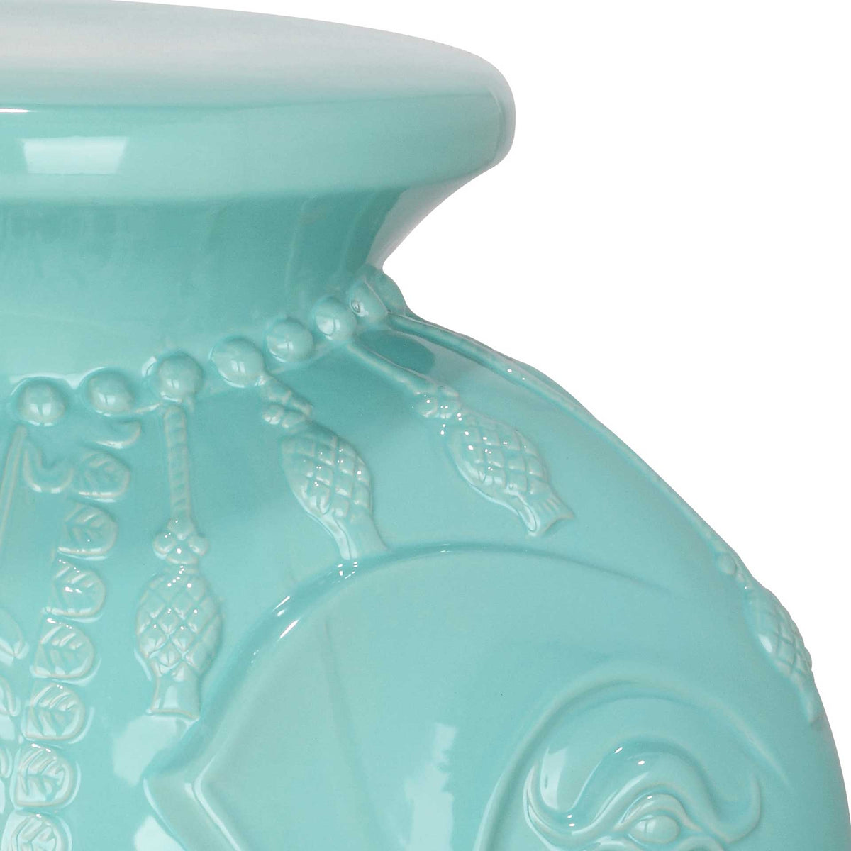 Glossy blue glaze highlights the elephant's sculpted ear and delicate dangling motifs.
