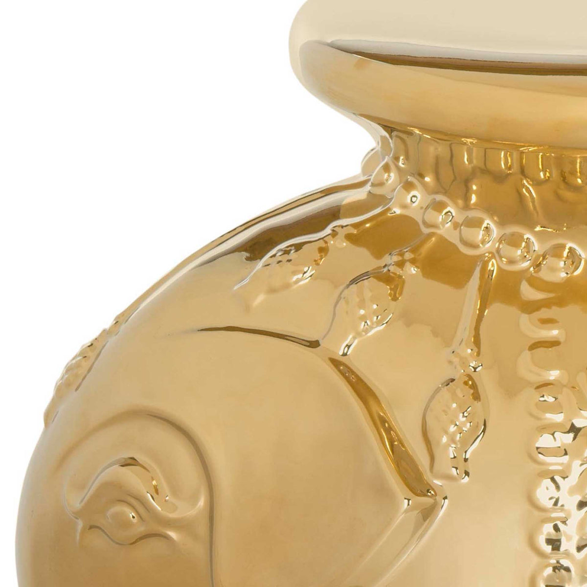 Reflective gold glaze highlights the elephant's sculpted ear and delicate hanging ornaments.