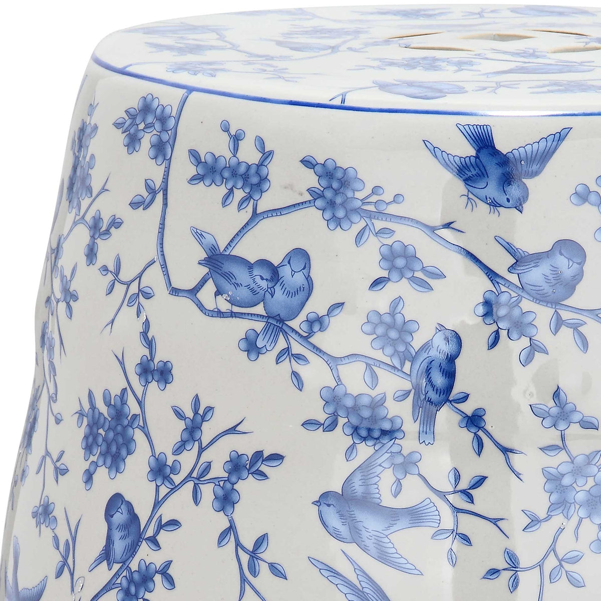 Glazed ceramic surface displays delicate blue birds among flowering branches