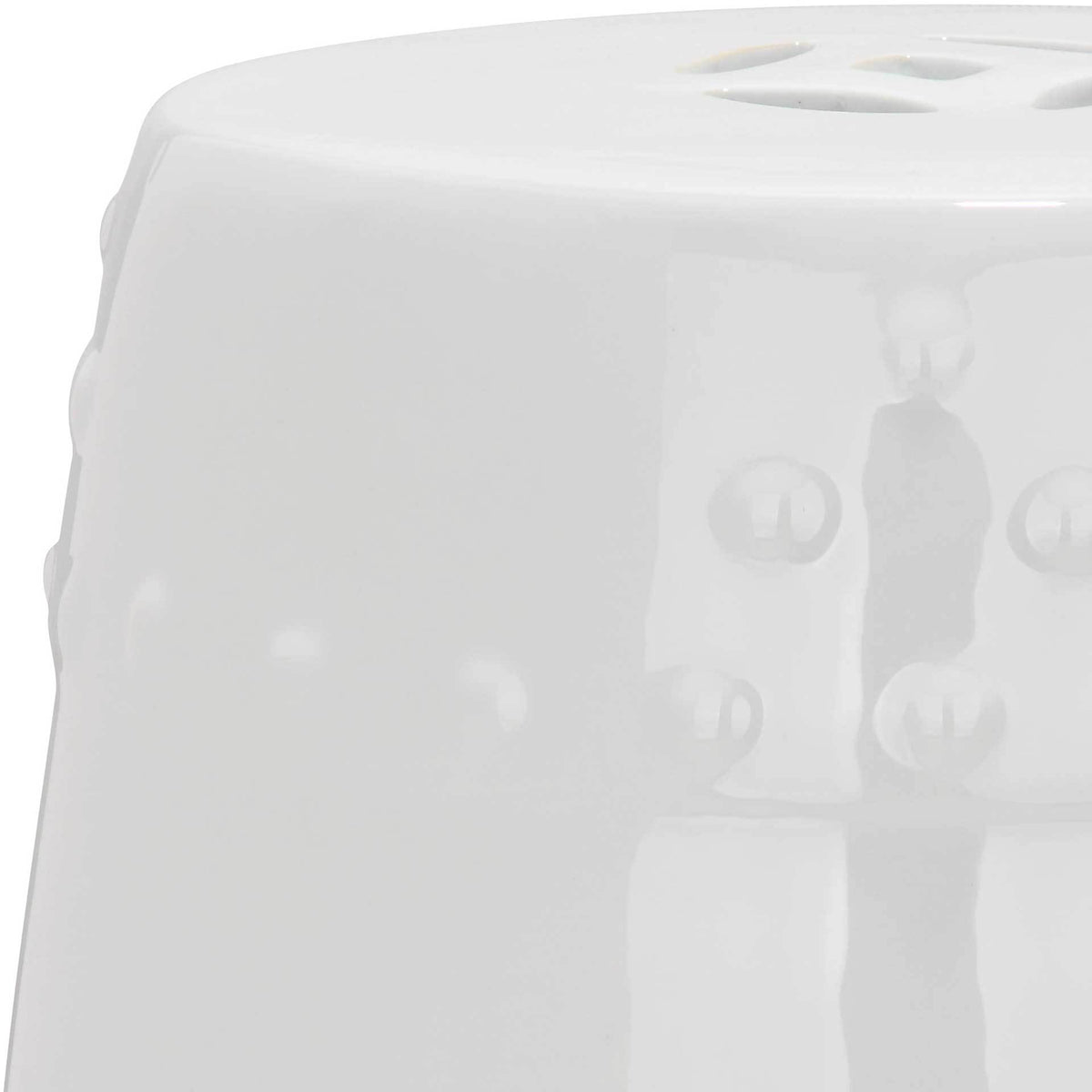 Glossy white glaze highlights the smooth top and subtle raised dot pattern.