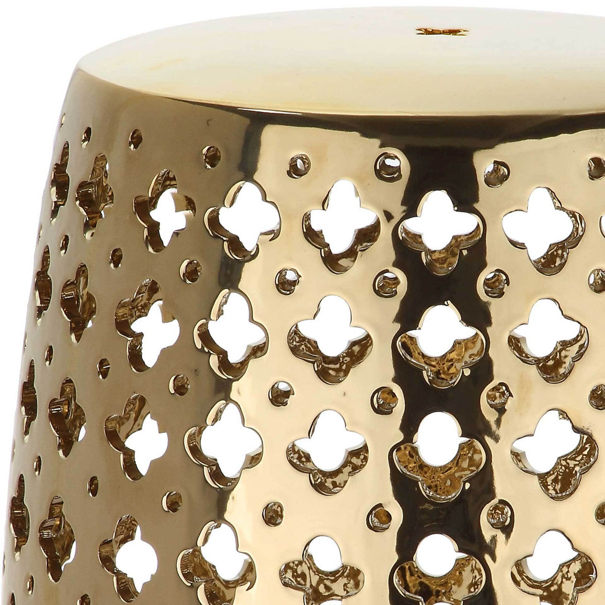 Reflective gold glaze highlights the clover-shaped openings and dotted detailing