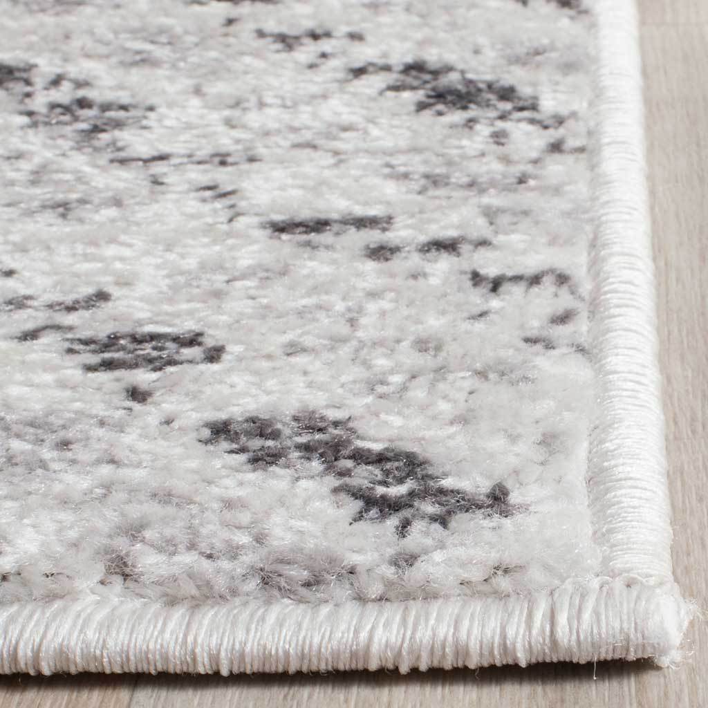 Neatly bound ivory edges frame a textured pile flecked with charcoal