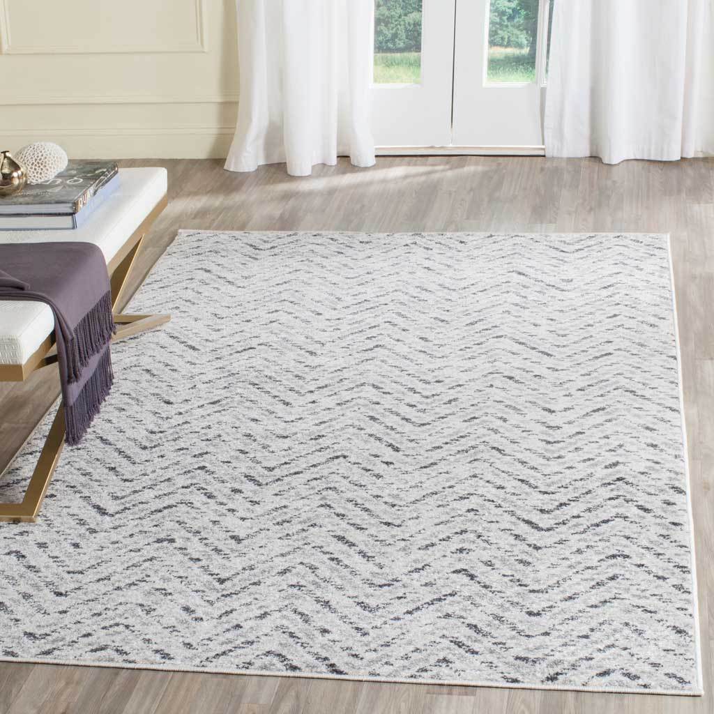 An ivory and charcoal chevron rug adds quiet pattern to a bright living space