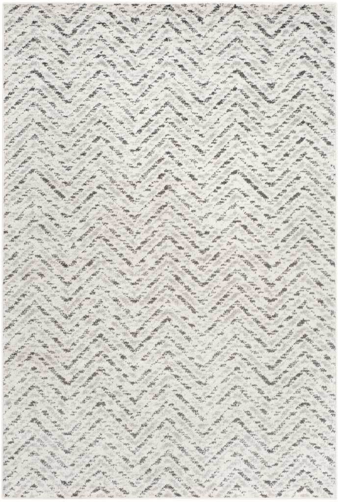 Ivory and charcoal chevrons create a gently distressed pattern on this rectangular rug