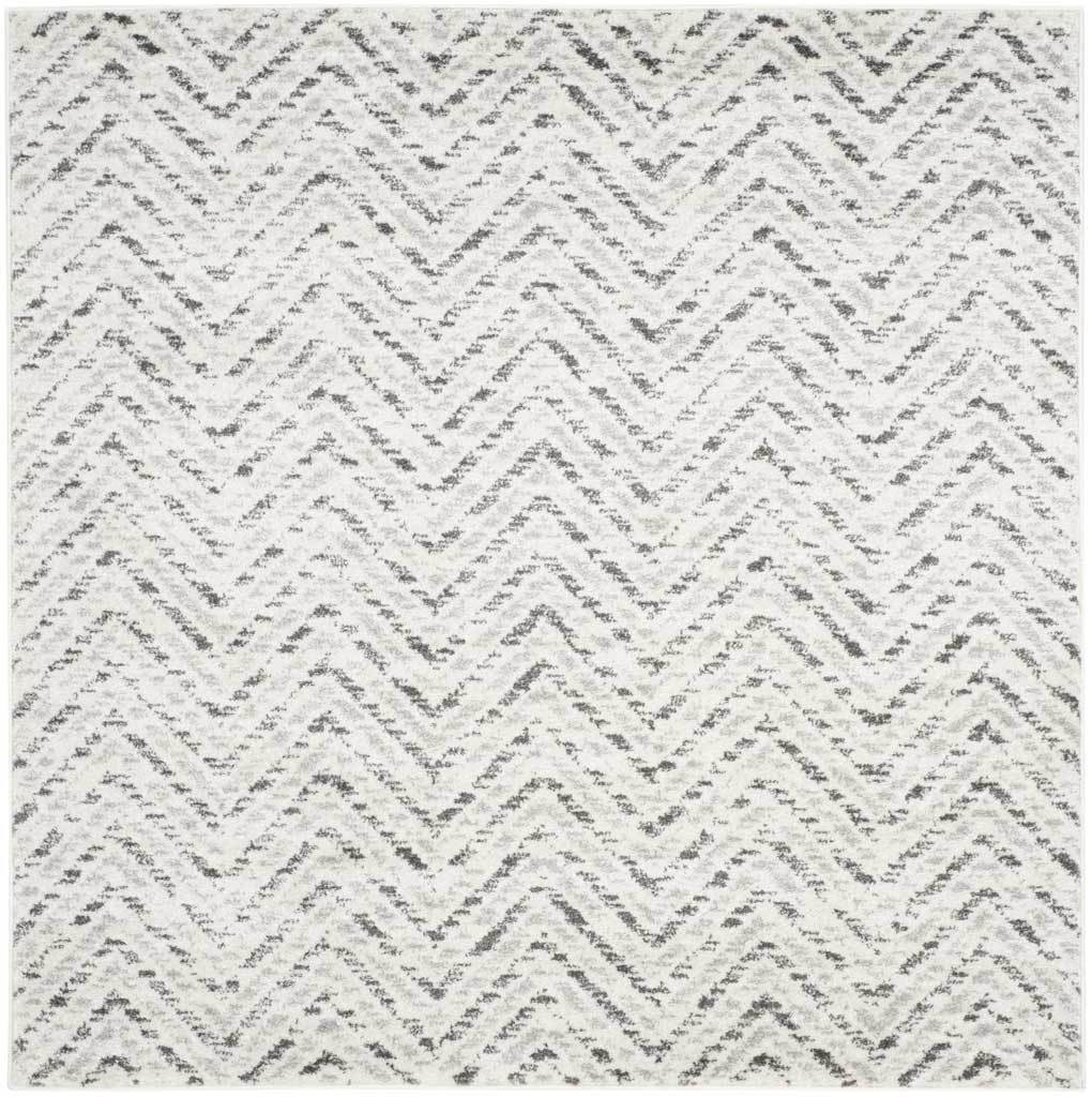 Square ivory rug layered with charcoal chevrons for a balanced, graphic accent