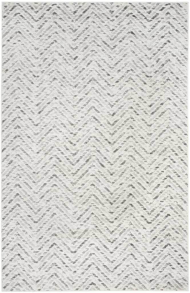 Subtle charcoal zigzags ripple across this ivory rectangular rug