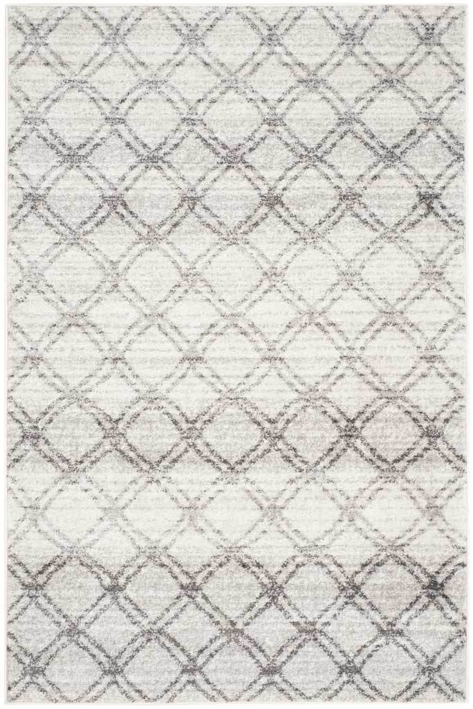 Layered charcoal trellis lines give this silver rug a softly faded geometric look