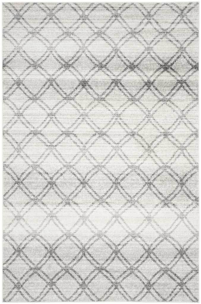 Charcoal lattice lines sweep across a silver rug with a softly weathered finish