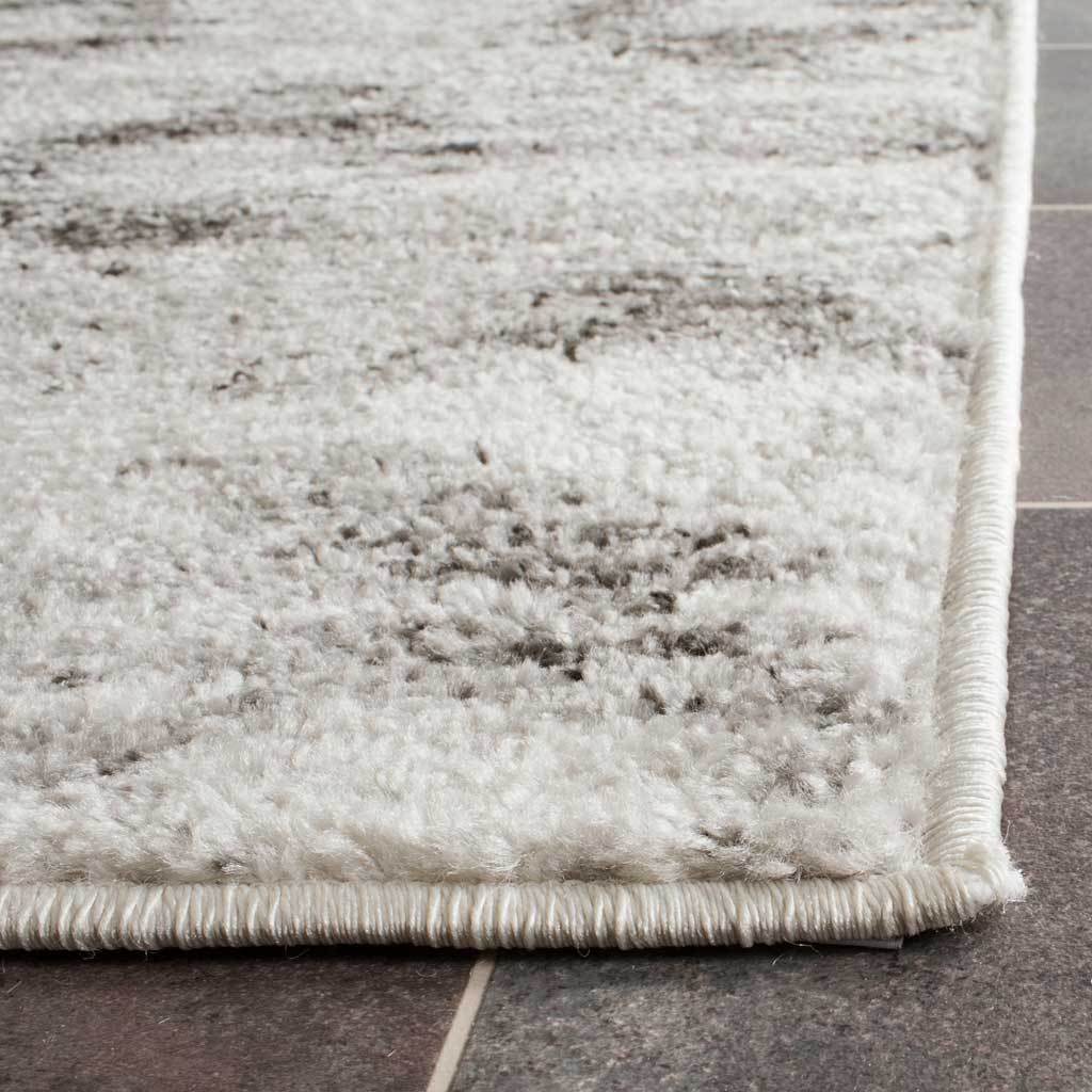 Soft silver-gray pile and neatly bound edges create a clean, tailored finish