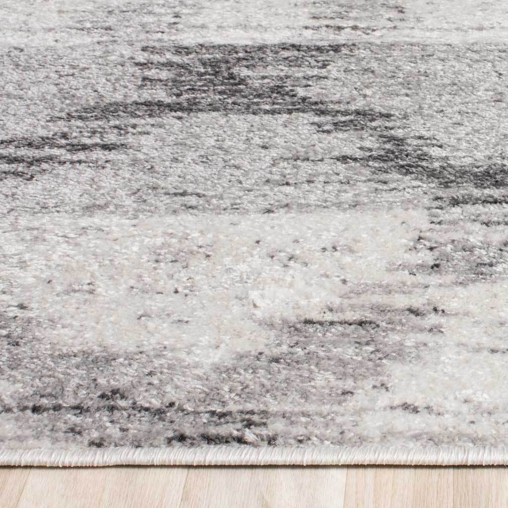 Textured silver pile is accented by charcoal streaks and a neatly bound edge