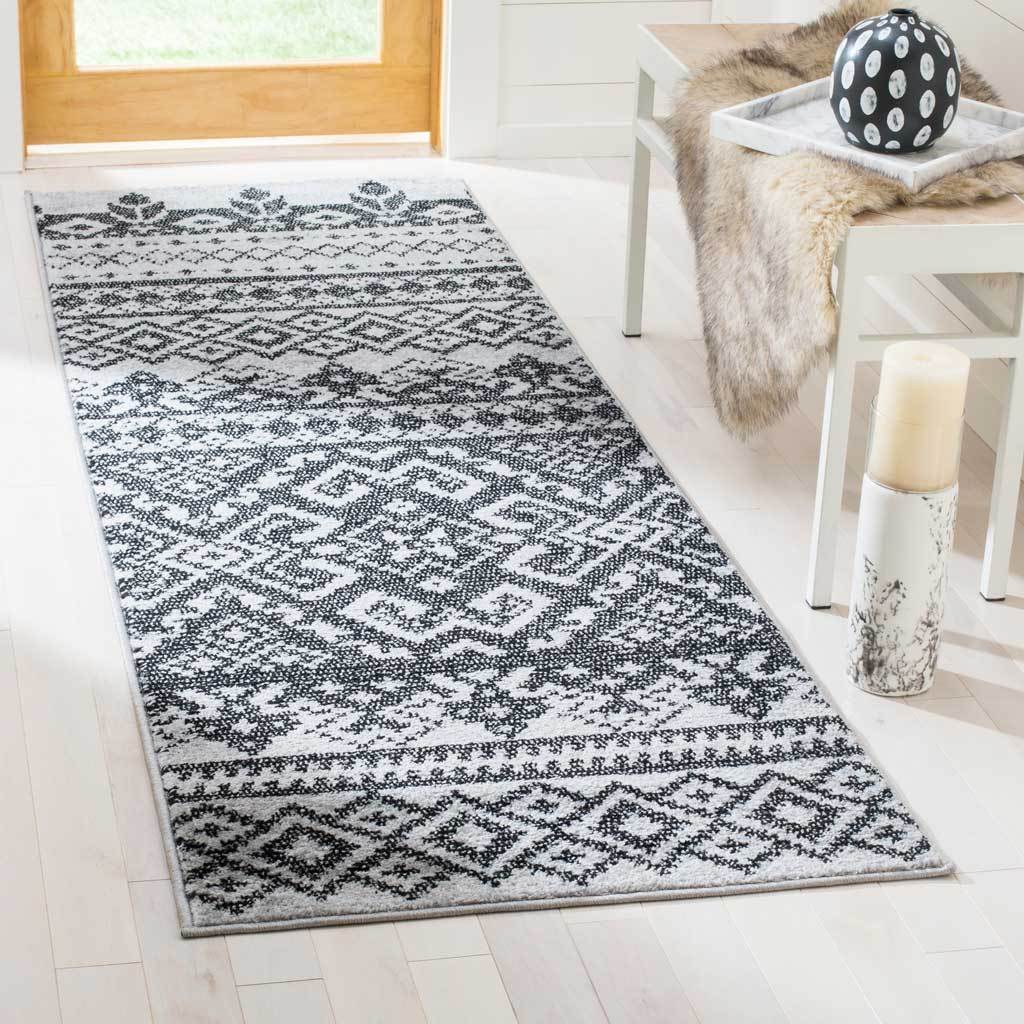 High-contrast geometric motifs give this silver and black runner a striking look