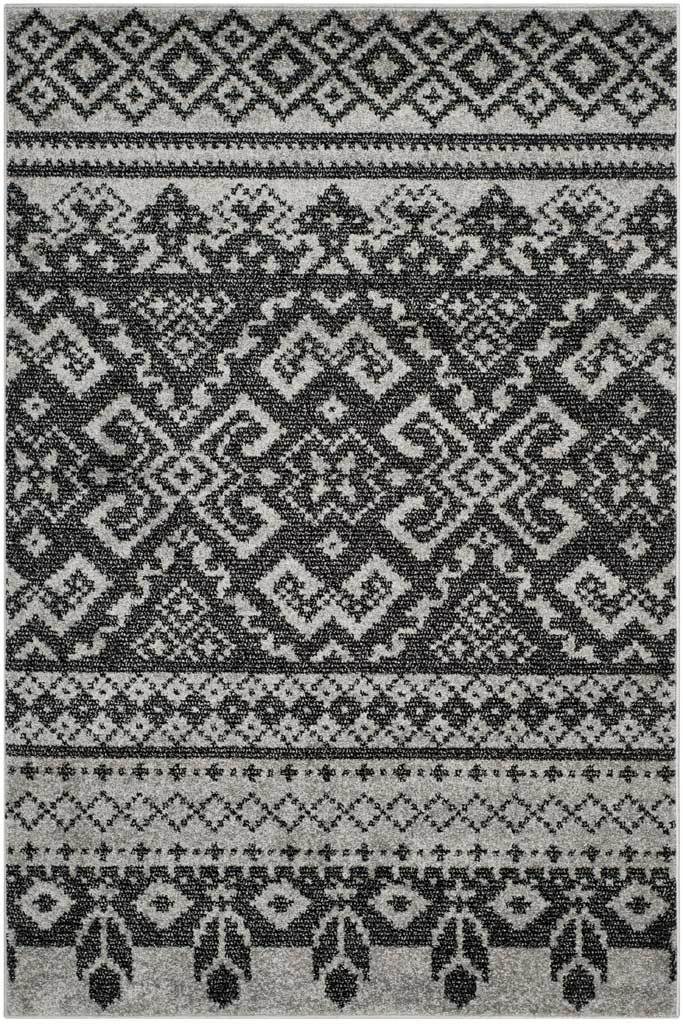 Black geometric medallions stand out against silver, with ornate end borders adding layered detail.