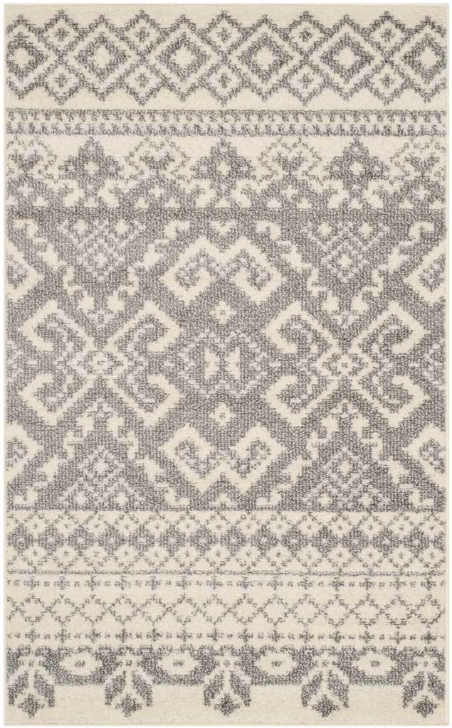 Compact ivory and silver rug centers an ornate diamond medallion between geometric and floral bands.