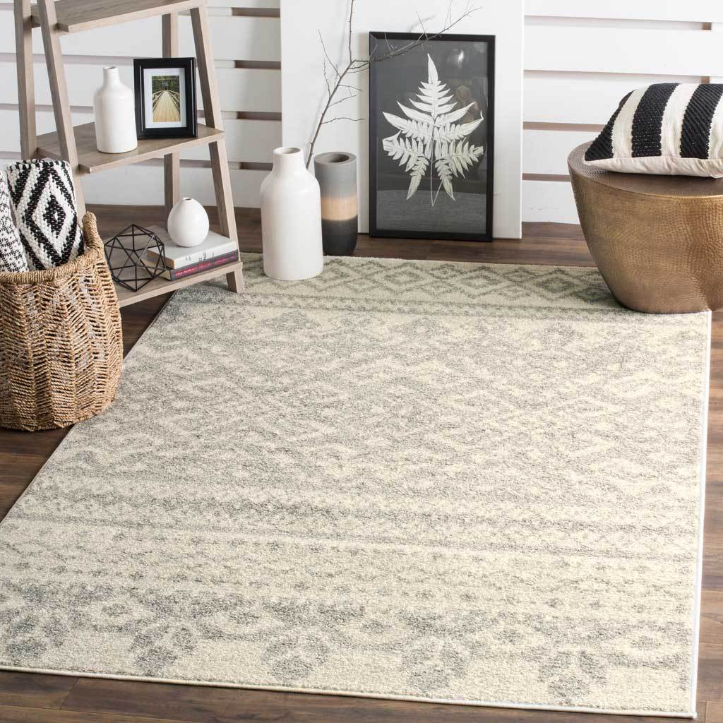 Muted ivory and silver geometrics lend gentle texture and pattern to a welcoming living area.