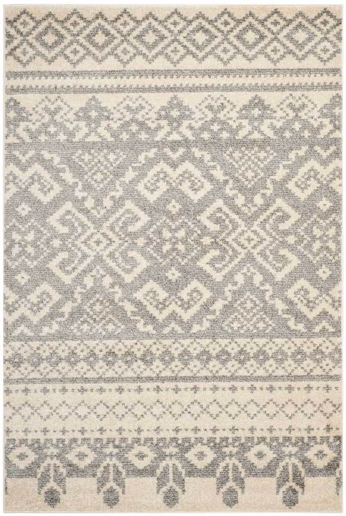 Ivory and silver rug layers ornate diamonds and floral motifs between patterned end borders.