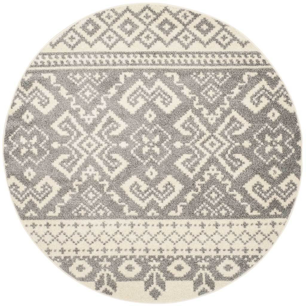 Silver and ivory diamonds repeat across this round rug with richly patterned border bands.