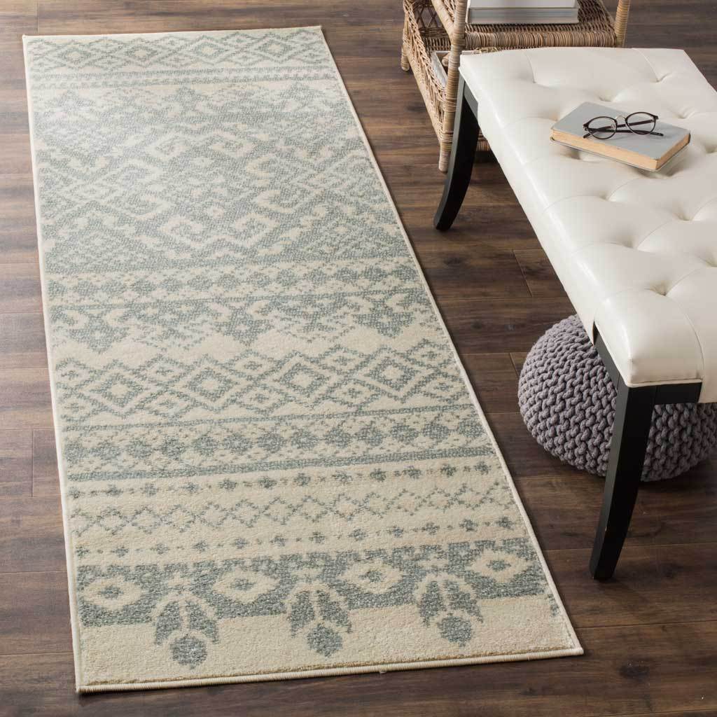 Soft ivory and slate hues bring diamond and botanical motifs to this runner