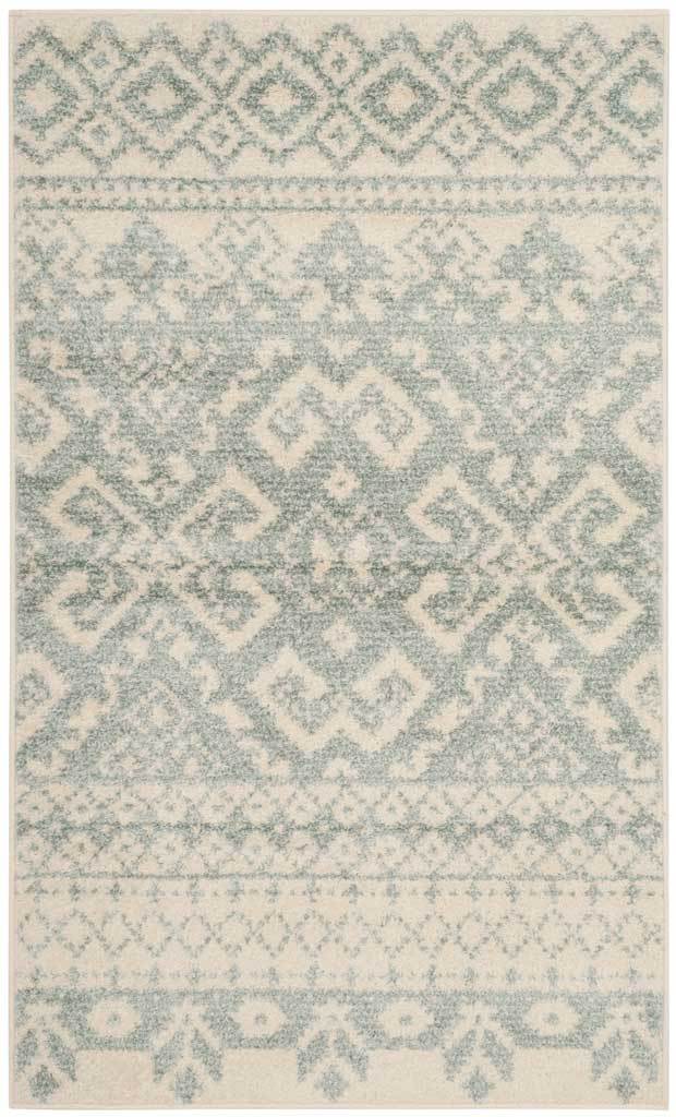 Compact ivory and slate rug highlights a bold diamond medallion framed by floral and geometric bands.