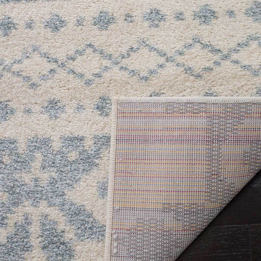Ivory edging secures the soft slate-patterned pile to a tightly woven underside.