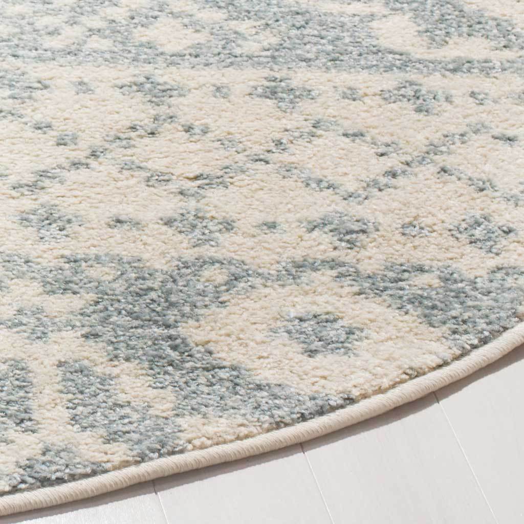 Soft ivory and slate fibers meet a neatly bound curved edge for a refined finish.