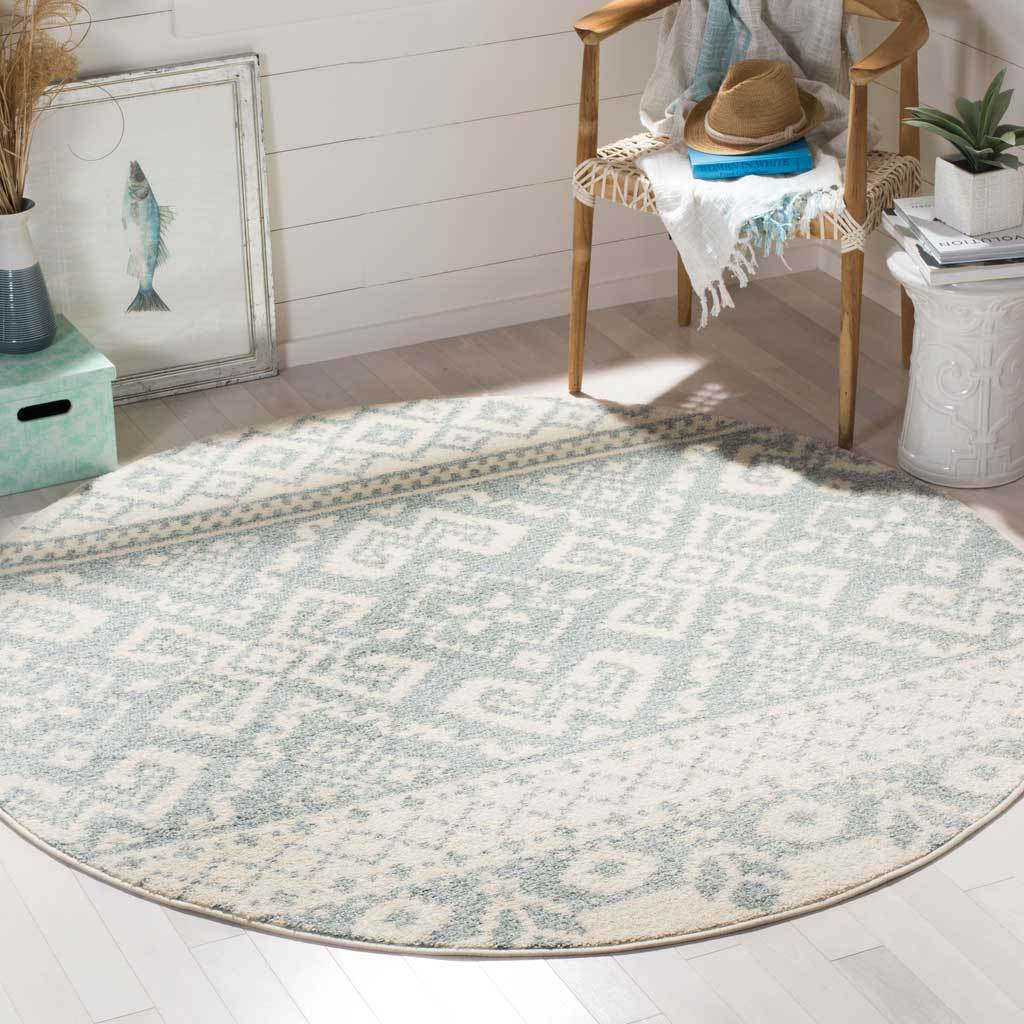 This ivory and slate round rug brings softly faded geometric pattern to a bright, inviting space.